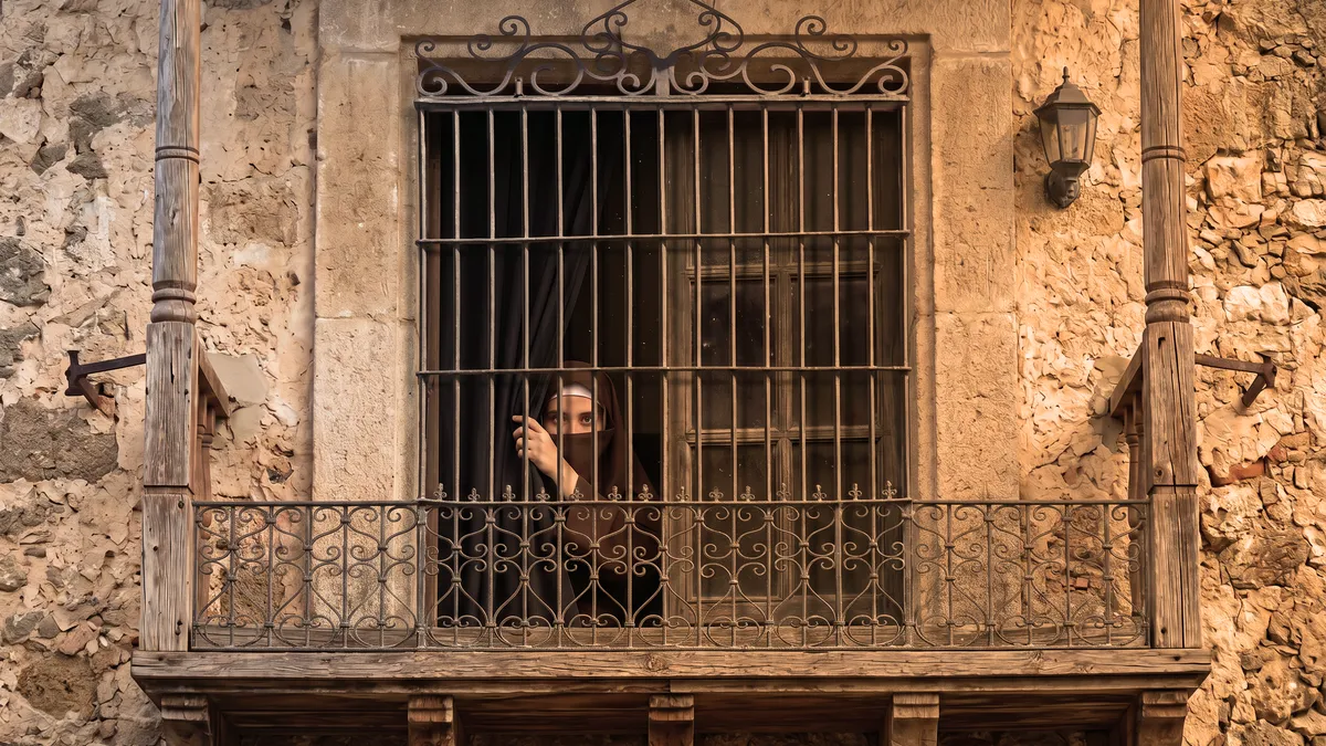 Celina asomando a una ventana del claustro de Santa Catalina.